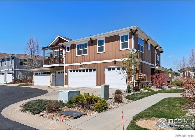 5850 Dripping Rock Ln Unit D201, Fort Collins, CO 80528 - view of property featuring board and batten siding, concrete driveway, and an attached garage