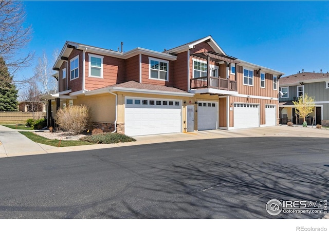5850 Dripping Rock Ln Unit D201, Fort Collins, CO 80528 - multi unit property with stone siding, an attached garage, and a pergola