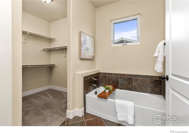 5850 Dripping Rock Ln Unit D201, Fort Collins, CO 80528 - full bath with a walk in closet, baseboards, and a bath