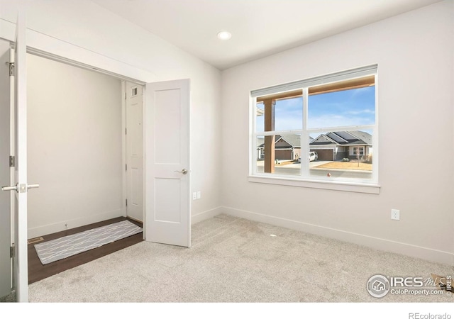 unfurnished bedroom with recessed lighting, baseboards, and carpet floors