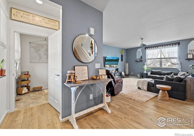 living area featuring baseboards and wood finished floors