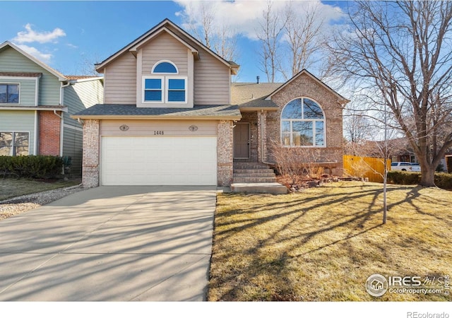 view of front of home with driveway, an attached garage, a front yard, and brick siding