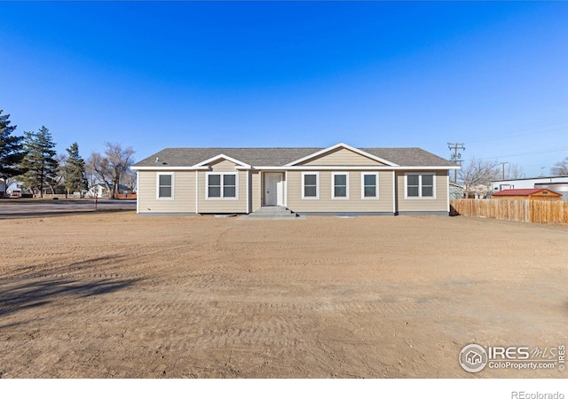 single story home featuring fence