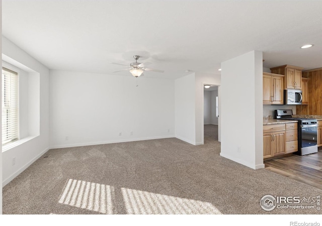 unfurnished living room featuring carpet floors, recessed lighting, ceiling fan, and baseboards