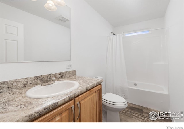 full bath with toilet, wood finished floors, vanity, visible vents, and shower / bath combination with curtain