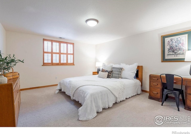 carpeted bedroom with visible vents and baseboards