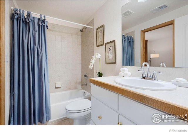 bathroom featuring toilet, shower / bath combination with curtain, vanity, and visible vents