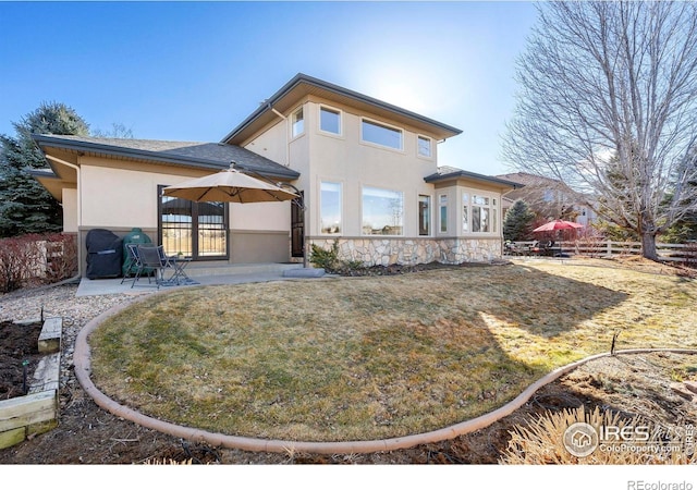 rear view of property featuring a patio area, fence, and stucco siding