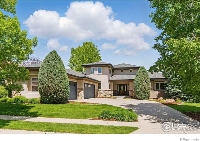 4405 Fairway Ln, Broomfield, CO 80023 - prairie-style house with a garage, stucco siding, concrete driveway, a front lawn, and stone siding