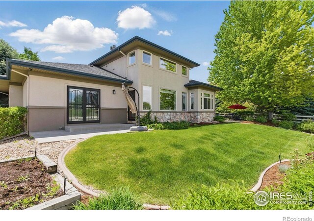 4405 Fairway Ln, Broomfield, CO 80023 - rear view of property with stucco siding, a lawn, and stone siding