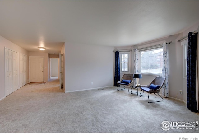 unfurnished room featuring carpet and baseboards