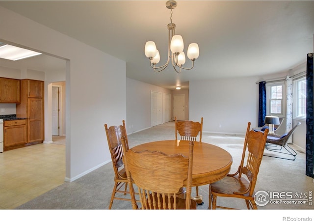 dining room with baseboards, light colored carpet, and an inviting chandelier