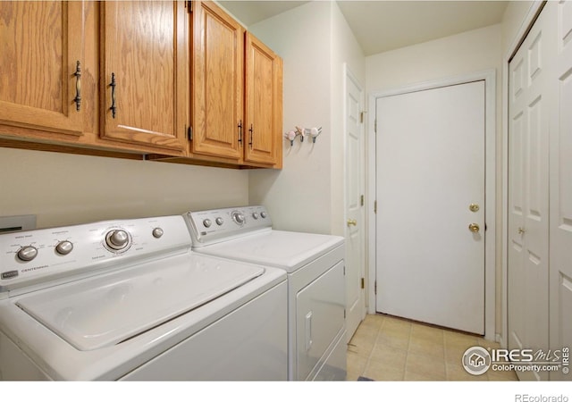 clothes washing area with cabinet space and washer and clothes dryer