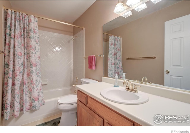 full bath featuring shower / bath combo, tile patterned flooring, vanity, and toilet