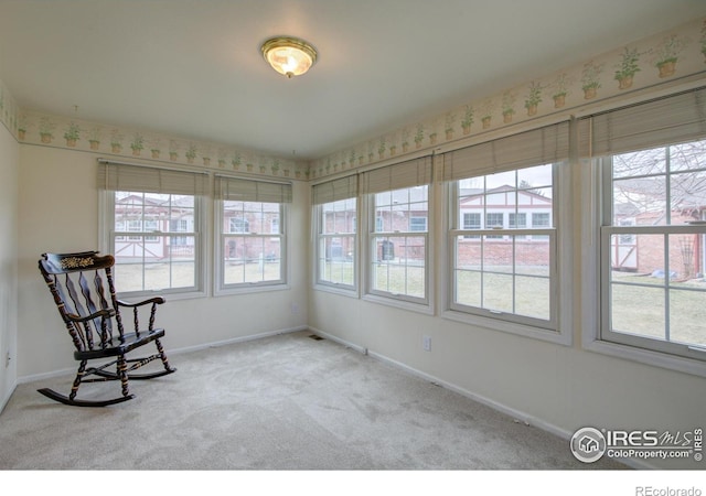 sitting room with carpet, plenty of natural light, and baseboards