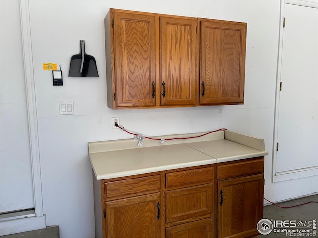 kitchen with light countertops and brown cabinetry