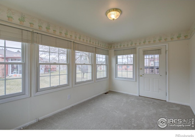 unfurnished sunroom featuring visible vents