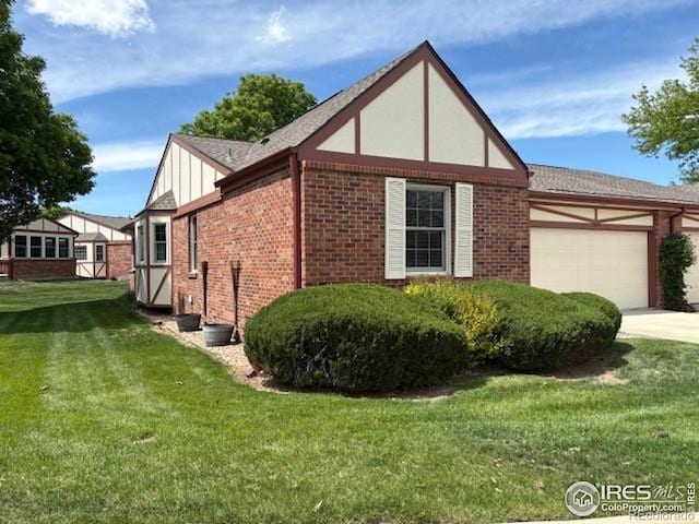 2604 Elmhurst Cir, Longmont, CO 80503 - view of side of home with brick siding, a garage, a lawn, and concrete driveway