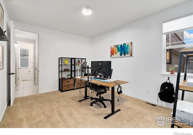 office area with carpet flooring, visible vents, and baseboards