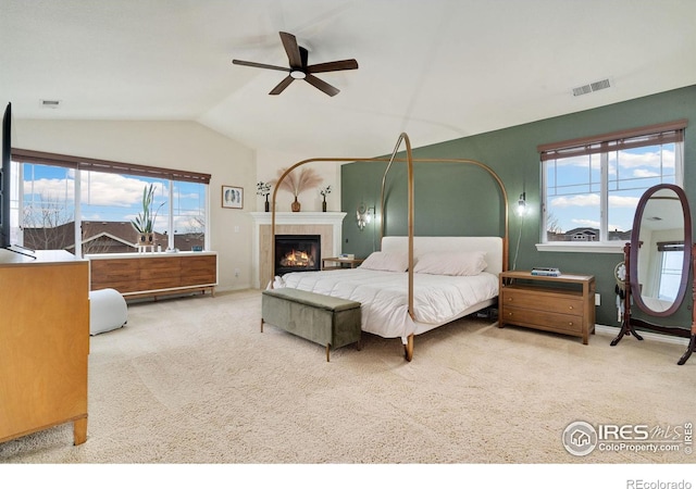 bedroom with lofted ceiling, multiple windows, carpet flooring, and visible vents