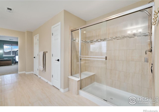 full bath featuring a stall shower, baseboards, and visible vents