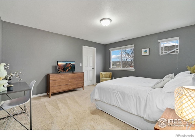 bedroom featuring baseboards and carpet flooring