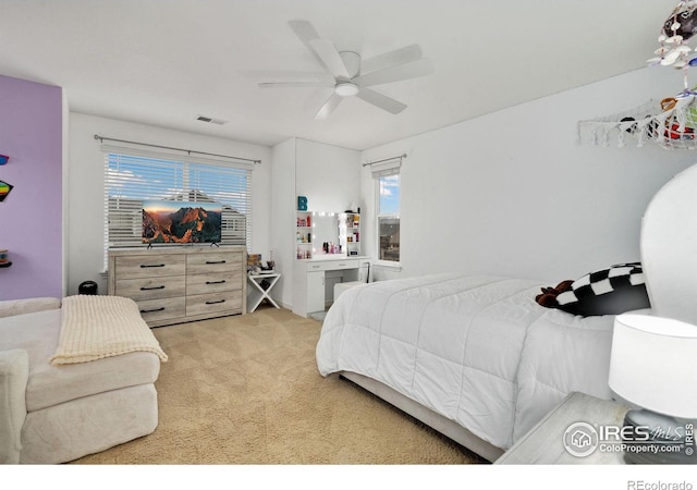 bedroom featuring light carpet, ceiling fan, and visible vents