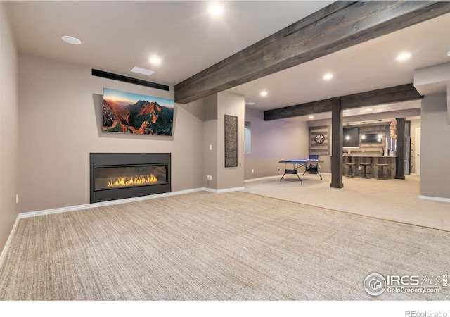 below grade area with recessed lighting, baseboards, carpet flooring, and a glass covered fireplace