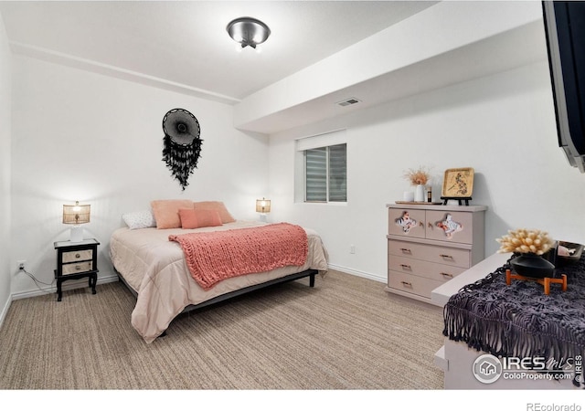 bedroom with carpet floors, visible vents, and baseboards