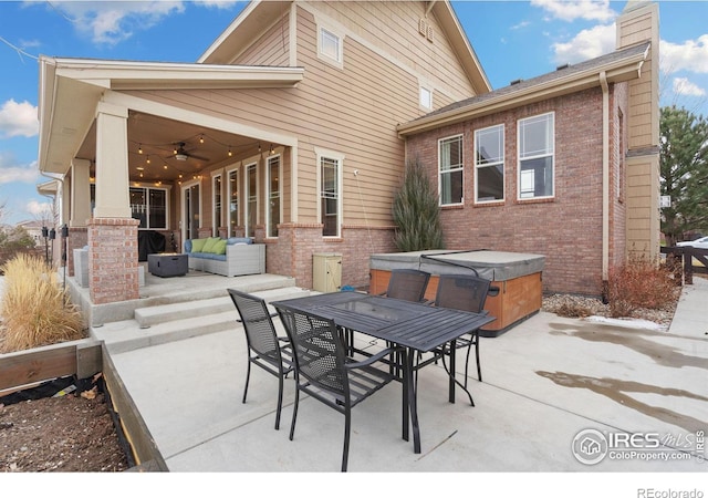 view of patio with a hot tub, an outdoor hangout area, outdoor dining area, and a ceiling fan