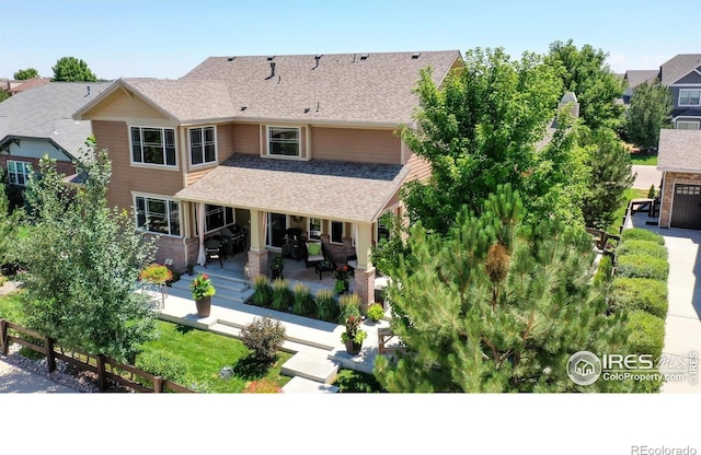 rear view of house with a shingled roof