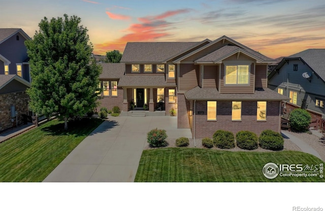 view of front of property featuring a front yard and brick siding