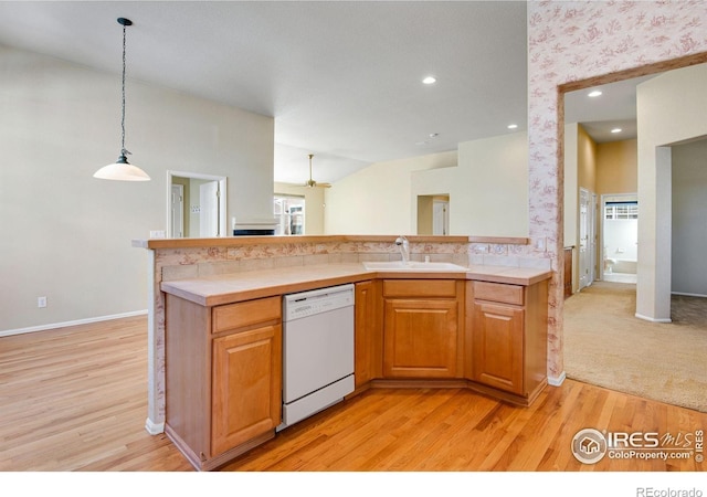 kitchen with decorative light fixtures, tile countertops, light wood finished floors, a sink, and dishwasher