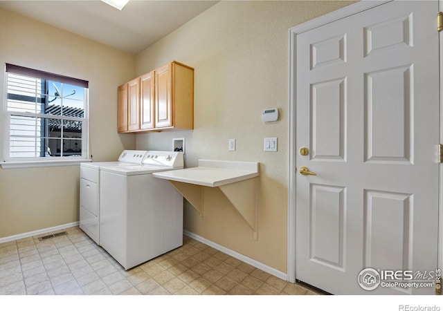 washroom with cabinet space, visible vents, independent washer and dryer, and baseboards