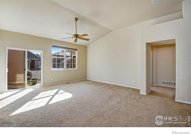 unfurnished room featuring carpet floors, lofted ceiling, visible vents, ceiling fan, and baseboards