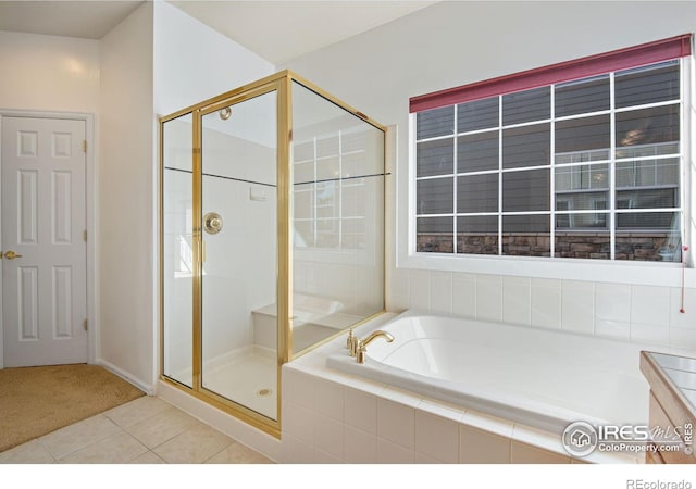 bathroom with a garden tub, tile patterned flooring, and a shower stall