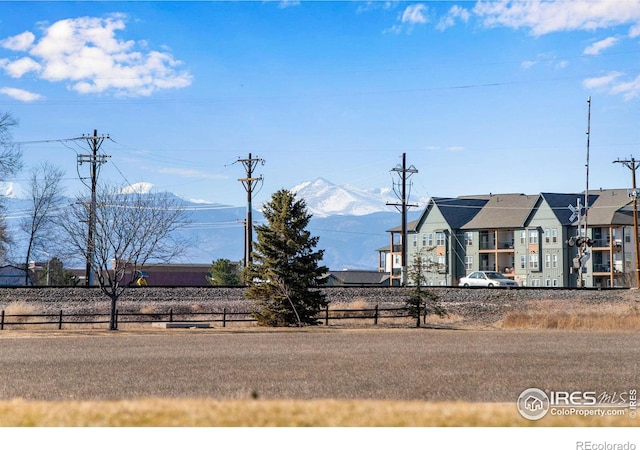 exterior space with fence and a mountain view