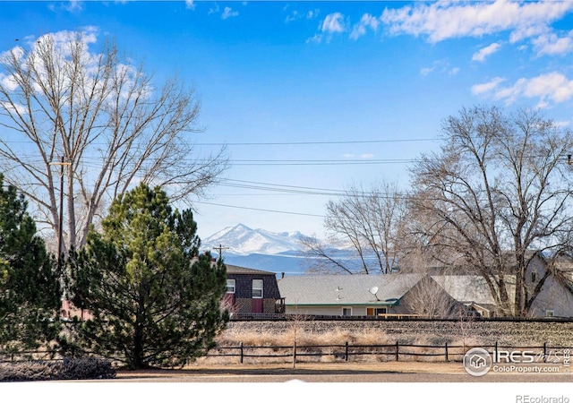 exterior space with a fenced front yard and a mountain view