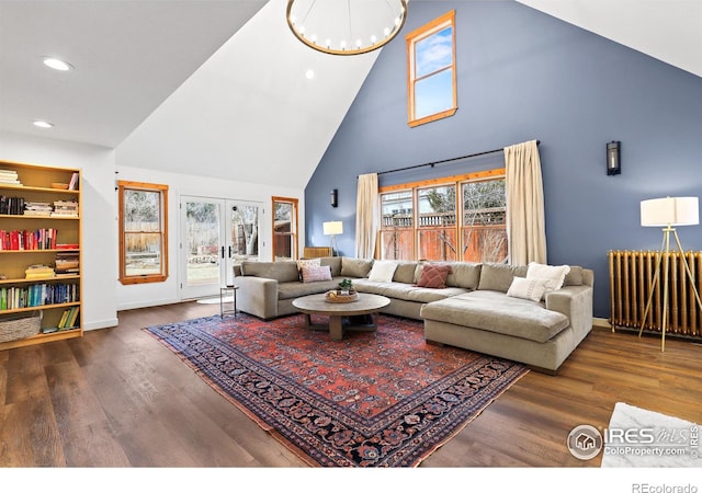 living room with a healthy amount of sunlight, radiator heating unit, wood finished floors, and french doors