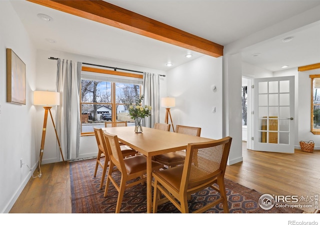 dining space with recessed lighting, baseboards, beamed ceiling, and wood finished floors