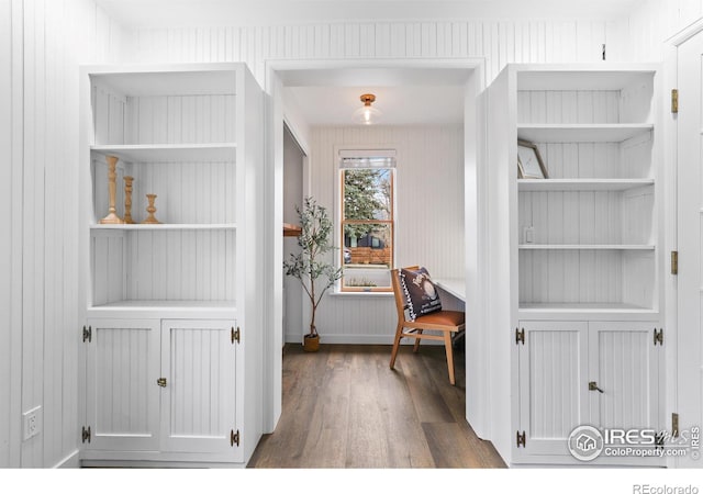 office area featuring built in shelves and wood finished floors