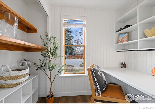 office area featuring built in desk, wood finished floors, and a healthy amount of sunlight