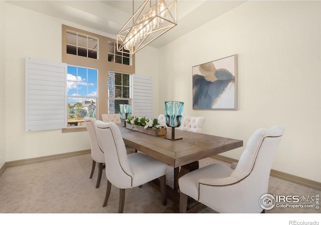 carpeted dining space with an inviting chandelier and baseboards