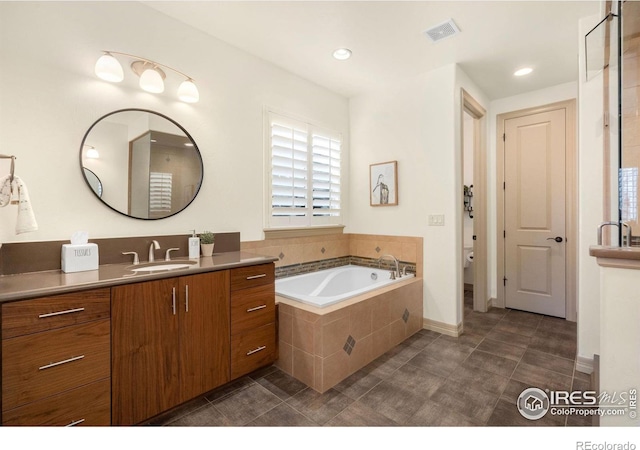 bathroom featuring visible vents, toilet, tile patterned flooring, vanity, and a bath