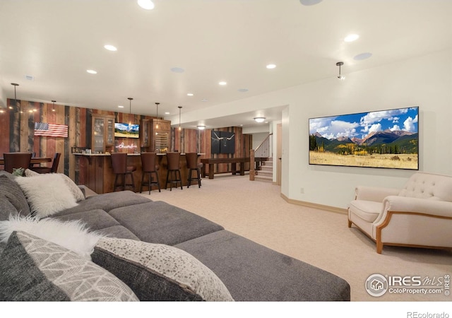 living area with a dry bar, light carpet, baseboards, stairs, and recessed lighting