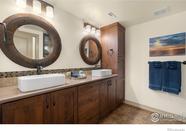 full bath with visible vents, a sink, and backsplash