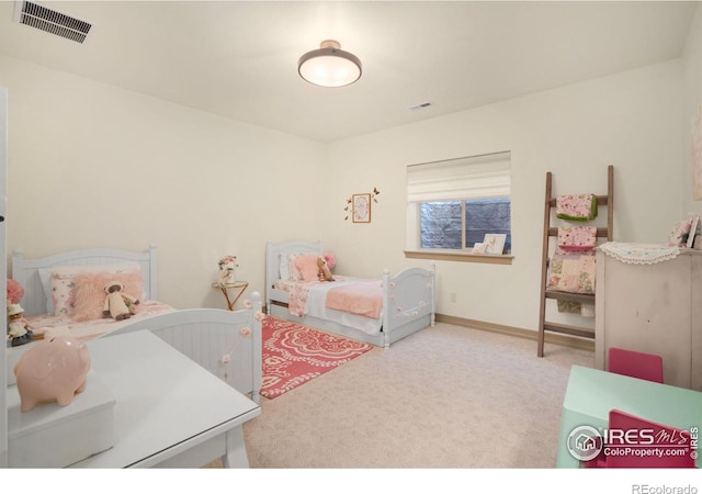 bedroom with carpet floors, visible vents, and baseboards