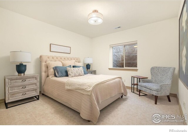 carpeted bedroom with baseboards and visible vents