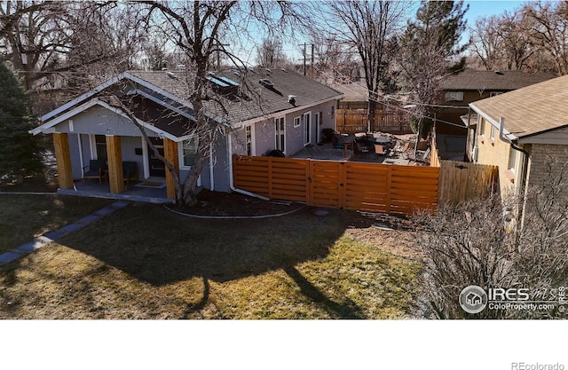 rear view of property with a patio area and fence