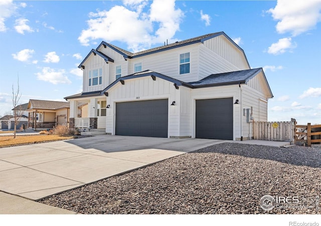 modern inspired farmhouse featuring board and batten siding, concrete driveway, fence, and an attached garage